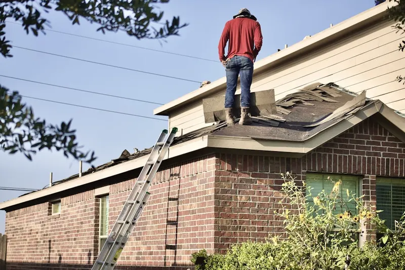 Professional roofer working on a residential roof in Clemson